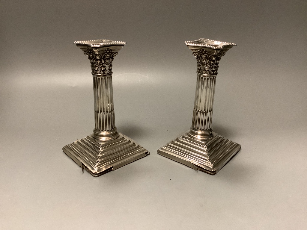 A foliate-cast circular silver bowl, Walker & Hall, Sheffield 1901 and a pair of silver Corinthian column dwarf candlesticks 8.25oz (weighable)